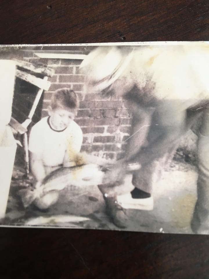 John helping his grandfather clean redfish in the mid-1970’s.